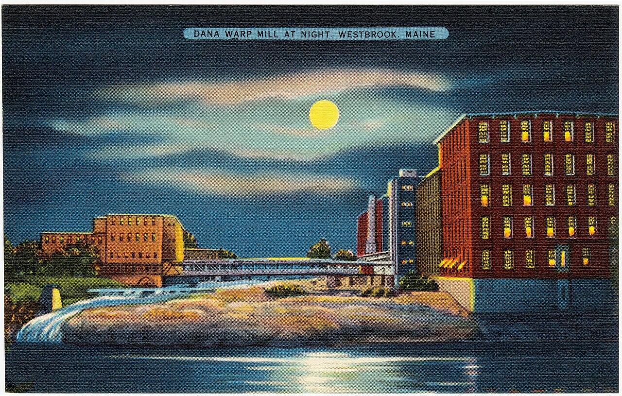 Vintage postcard of the Dana Warp Mill lit up at night beside Saccarappa Falls on the Presumpscot River in Westbrook, Maine