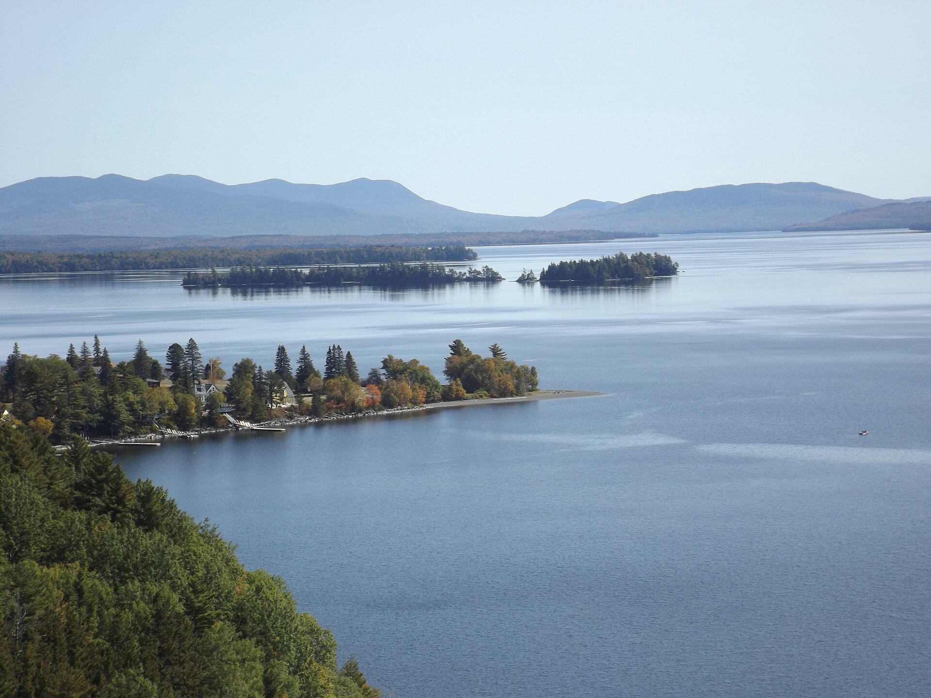 Island-studded view of Moosehead Lake with forested shores and distant mountains in Maine's North Woods