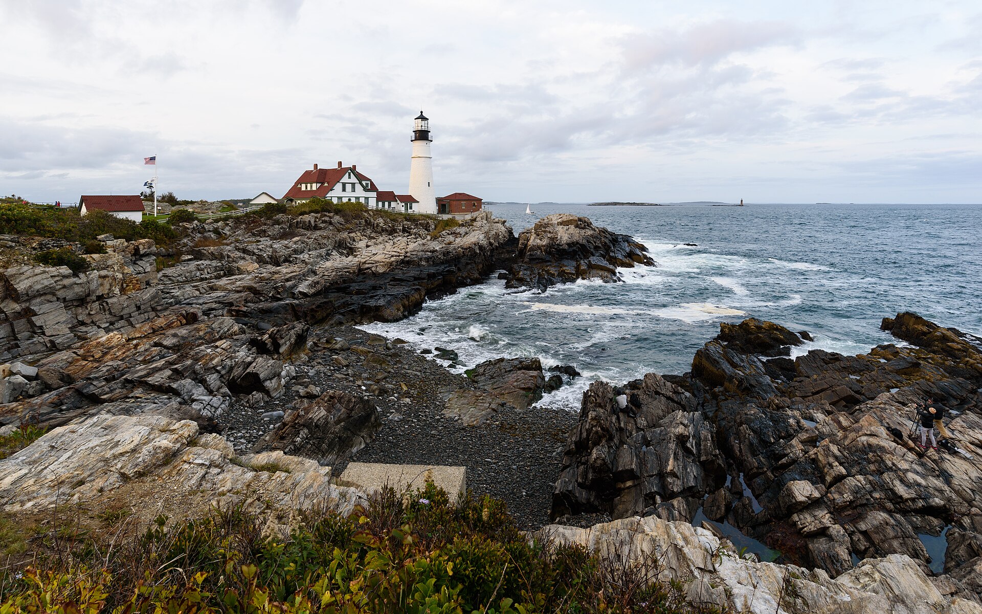 Portland Head Light and its keeper's house on the rocky headland at Cape Elizabeth, Maine, with surf below
