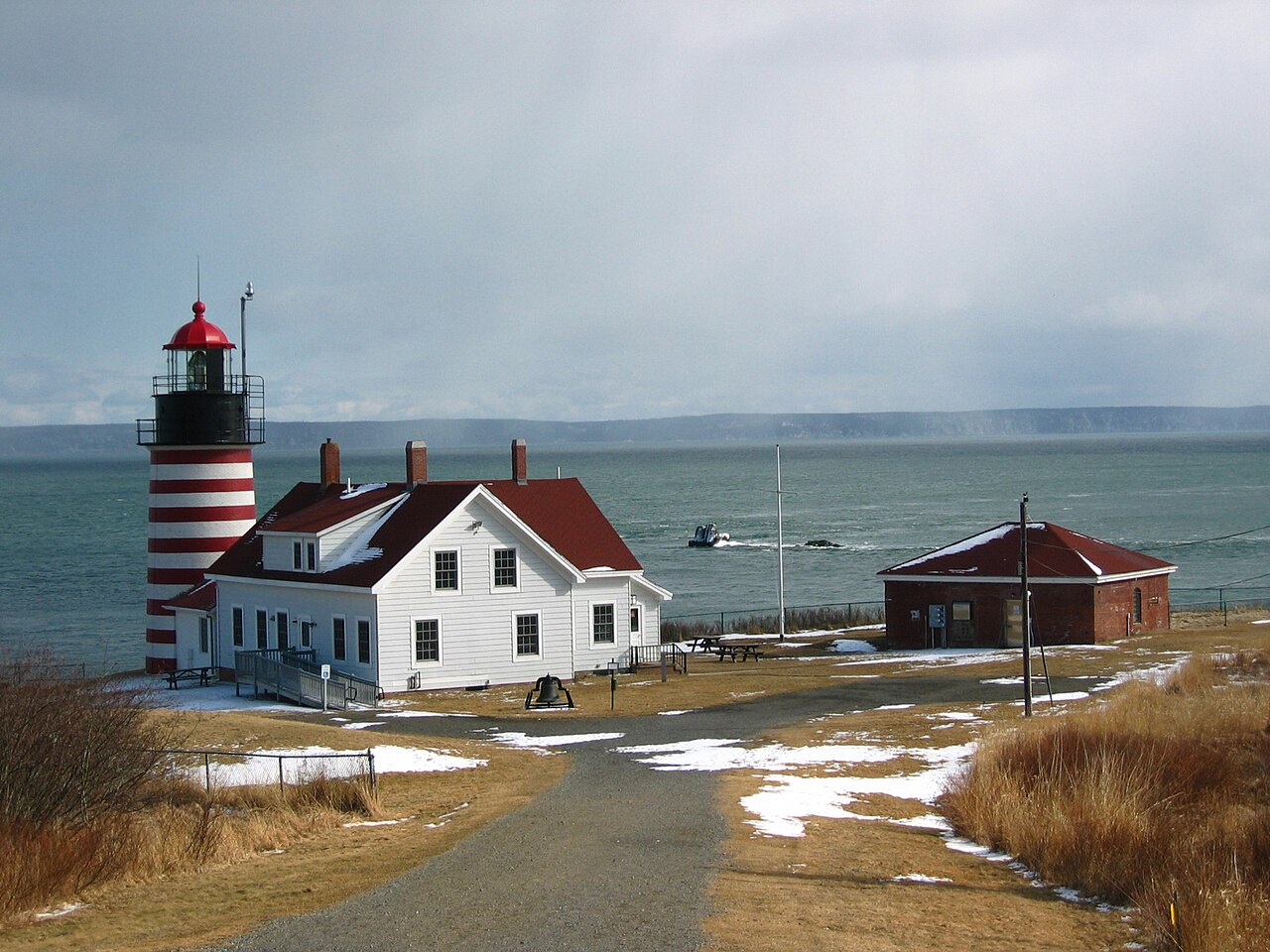 The red-and-white striped West Quoddy Head Light with its keeper's house on the coast at Lubec, Maine